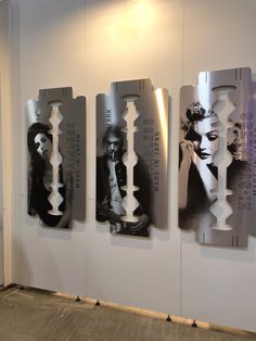 three pieces of art are hanging on the wall