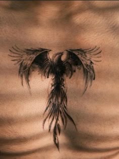 a man's chest with an eagle tattoo on his chest and the wings spread out