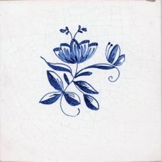 a blue and white tile with some flowers on it's side, in the shape of a flower