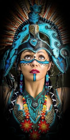 a woman with blue makeup and headdress