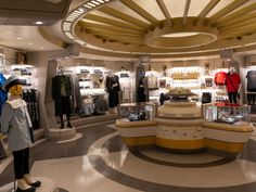 the inside of a clothing store with mannequins and other items on display