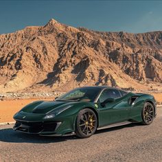 a green sports car parked in the desert