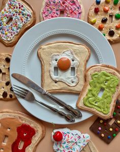 a white plate topped with lots of different types of cookies and pastries on top of a table