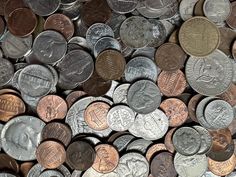 many different types of coins are stacked on top of each other