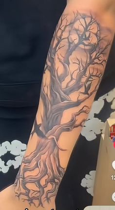 a person with a tree tattoo on their arm