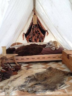 the interior of a tent with fur on the floor