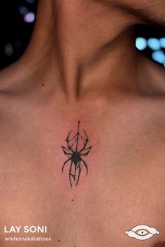 a man's chest with a spider tattoo on the upper part of his chest