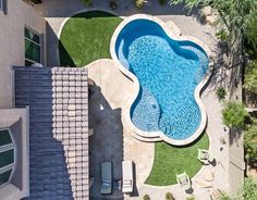 an aerial view of a swimming pool and patio