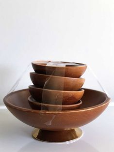 a stack of wooden bowls sitting on top of each other