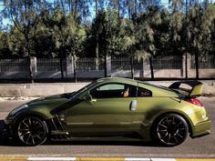 a green sports car parked on the side of the road
