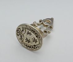 A silver Fob Seal, circa 1775, Europe. Silver Fob Seal, Victorian Wax Seal Ring, Antique French Wax Seal Jewelry, Victorian Silver Seal, Victorian Silver Signet Ring For Gift, Vintage Silver Seal, Antique Fob Wax Seal James, Vintage Seal Fob, Ornate Wax Seal Jewelry