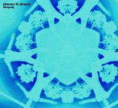 an abstract blue and white photo with trees in the center, surrounded by snowflakes