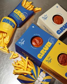 three boxes of churros and french fries on a table