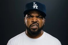 a close up of a person wearing a baseball cap and looking at the camera with an angry look on his face