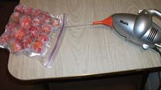 a hair dryer sitting on top of a table next to a bag of fruit