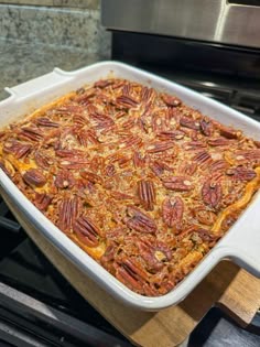 a casserole dish with pecans in it sitting on top of the stove