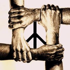 two hands holding each other in front of a peace sign
