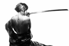 a woman with a knife in her mouth