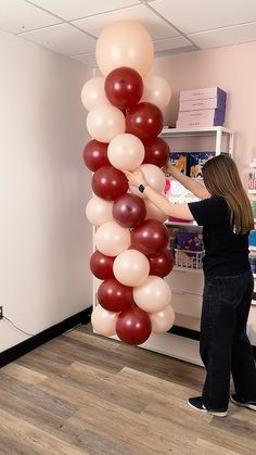 a woman standing next to a giant balloon