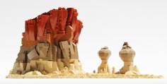 two sculptures made out of legos sitting next to each other