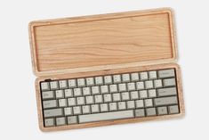 an apple keyboard in a wooden case