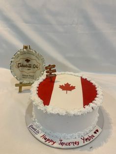 a birthday cake decorated with the flag of canada and an award for best bakery in canada