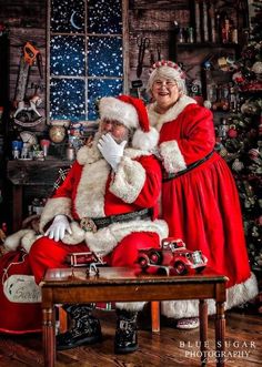 a man and woman dressed as santa claus