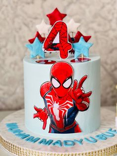 the birthday cake is decorated with an image of spider - man