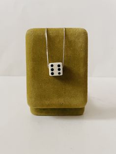 Our vintage dice necklaces have finally made it to the shop. Each necklace includes ONE vintage die of your color choice and the option of a sterling silver or gold plated sterling chain. Chain length options include: 16", 18", 20".  Please note die shape/style may vary slightly. * Does not include green jewelry box shown in photo Diy Dice Necklace, Dice Jewelry, Dice Necklace, Dnd Dice Jewelry, Dungeons And Dragons Dice Jewelry, Dnd Dice Necklace, Vintage Dice Jewelry, Promotion Card, Green Jewelry