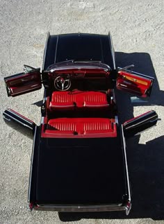 the back end of a black car with red seats