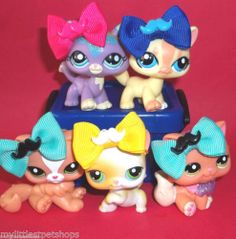 littlest pet shop toys sitting on top of each other