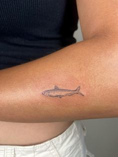 a woman with a fish tattoo on her arm