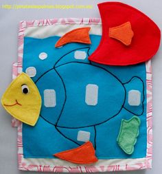 a close up of a piece of cloth with a fish on it and a red hat