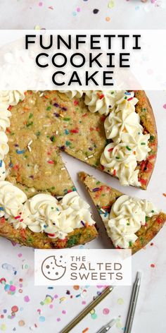 a cake with white frosting and sprinkles on it is cut into pieces