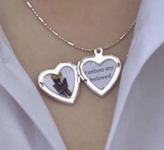 two heart shaped pendants with the words random my beloved on them are attached to a woman's chest