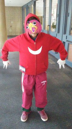 a person in a red jacket and pink pants is standing with his arms spread out