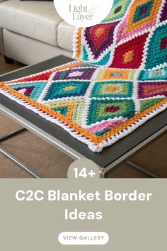 a crocheted blanket sitting on top of a table next to a white couch