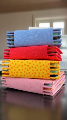 stack of folded fabric sitting on top of a wooden table