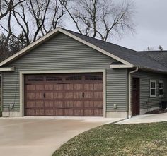 a gray house with a brown garage door
