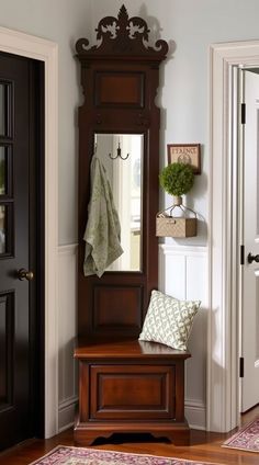 a wooden bench sitting in front of a mirror on top of a wall next to a doorway
