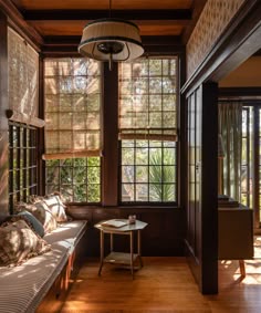 the sun shines through the windows in this room with wood paneling and wooden flooring