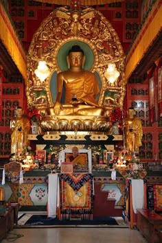 a large golden buddha statue sitting inside of a building