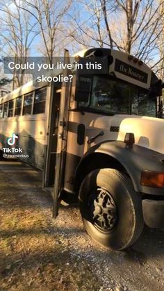 a school bus is parked on the side of the road with its door open and it says, could you live in this skoolie?