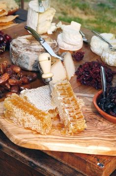 a wooden cutting board topped with lots of cheese