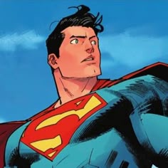 the man is wearing a superman suit and standing in front of a blue sky with clouds