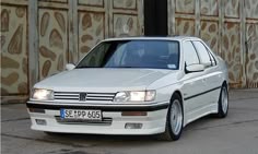 a white car parked in front of a building