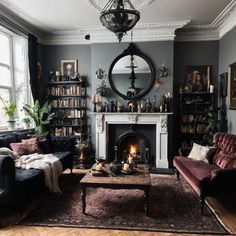 a living room filled with furniture and a fire place in the middle of a room
