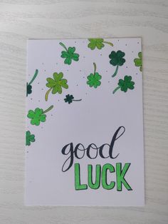 a greeting card with shamrocks and good luck written on it