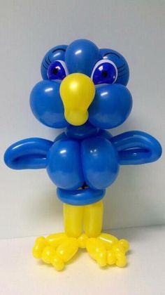 a blue balloon bird with big eyes and yellow feet