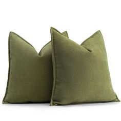 two green pillows sitting next to each other